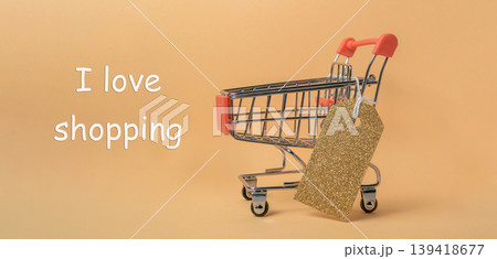 Shopping cart with a tag on it that says I love shopping Shopping cart with a tag on it that says I love shopping 139418677