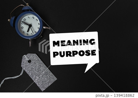 Blue alarm clock sits on a black background with the words Meaning Purpose Blue alarm clock sits on a black background with the words Meaning Purpose 139418862