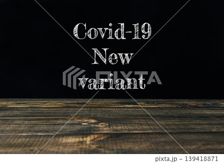Covid-19 new variant text displayed on a wooden table with dark background for informative purposes Covid-19 new variant text displayed on a wooden table with dark background for informative purposes 139418871