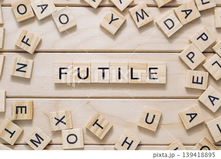 Jumble of wooden letters spell out the word futile on a wooden surface Jumble of wooden letters spell out the word futile on a wooden surface 139418895