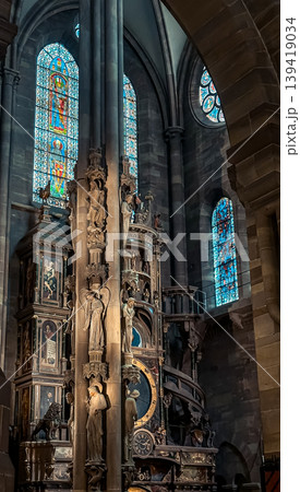 Intricate architectural details of a historic church interior featuring ornate sculptures and colorful stained glass windows illuminating the space Intricate architectural details of a historic church interior featuring ornate sculptures and colorful stained glass windows illuminating the space 139419034