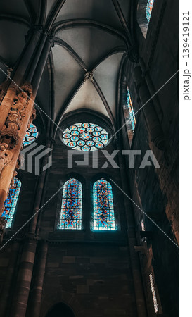 Stunning stained glass windows illuminate the interior of a historic cathedral, showcasing intricate designs and vibrant colors in a spiritual atmosphere Stunning stained glass windows illuminate the interior of a historic cathedral, showcasing intricate designs and vibrant colors in a spiritual atmosphere 139419121
