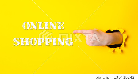 Hand pointing to the word online shopping on a yellow background Hand pointing to the word online shopping on a yellow background 139419242