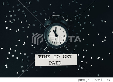 Black and white photo of a clock with the words "Time to get paid" written bel Black and white photo of a clock with the words "Time to get paid" written bel 139419275