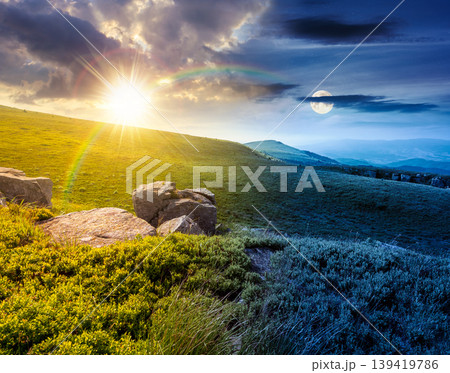 day meet night. mountain summer time landscape. sun and moon over meadow with giant stones among the grass on the hillside. epic view near the peak of mountain smooth at twilight. harmony concept day meet night. mountain summer time landscape. sun and moon over meadow with giant stones among the grass on the hillside. epic view near the peak of mountain smooth at twilight. harmony concept 139419786