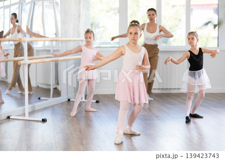 Girls in ballet class perform Batman with correction of female mentor 139423743