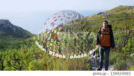 Hiking man in orange vest navigating coastal trail with backpack and hologram sphere, copy space Hiking man in orange vest navigating coastal trail with backpack and hologram sphere, copy space 139424993