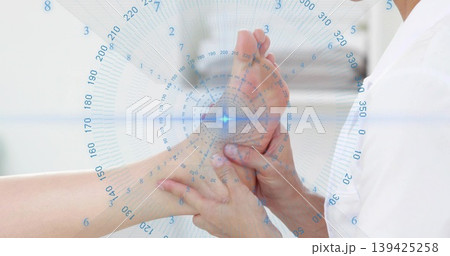 Clinician hands palpating patient foot in medical clinic, with blue holographic overlay Clinician hands palpating patient foot in medical clinic, with blue holographic overlay 139425258