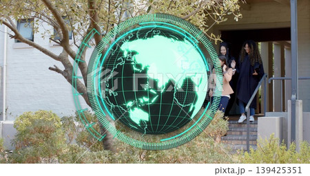 Projecting green holographic globe hovering at brick entrance railing and students descending steps 139425351