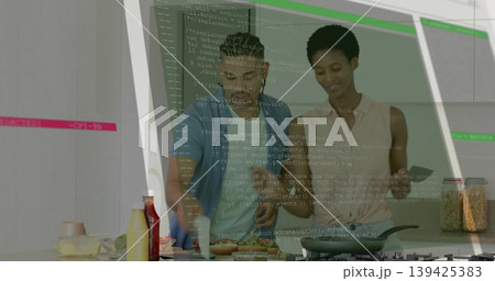 Spreading sauce on bread slices at home kitchen counter with smartphone guidance, using spatula Spreading sauce on bread slices at home kitchen counter with smartphone guidance, using spatula 139425383
