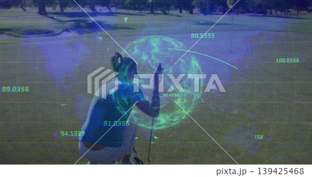 Crouching golfer holding putter aligning ball near hole on putting green, overlaying grid hologram Crouching golfer holding putter aligning ball near hole on putting green, overlaying grid hologram 139425468