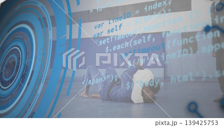 Martial artists practicing grappling in white-and-blue gi on blue mat in gym, with UI overlay Martial artists practicing grappling in white-and-blue gi on blue mat in gym, with UI overlay 139425753