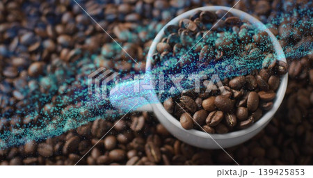 Showing white ceramic cup holding roasted coffee beans on tabletop, with turquoise data stream, arc 139425853