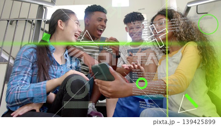 Teenage friends sharing smartphone screen in stairwell, with augmented reality code overlays Teenage friends sharing smartphone screen in stairwell, with augmented reality code overlays 139425899