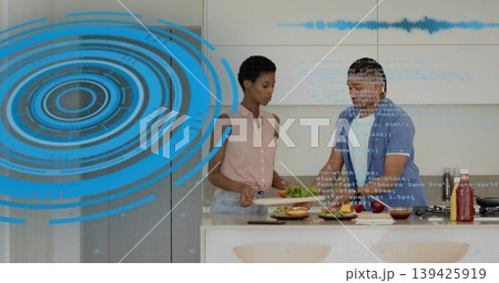 Slicing lettuce and assembling burgers by couple in modern home kitchen, with HUD overlay graphics Slicing lettuce and assembling burgers by couple in modern home kitchen, with HUD overlay graphics 139425919