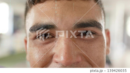 Looking adult male making direct eye contact at bright open hall, with numeric graphical overlay 139426035