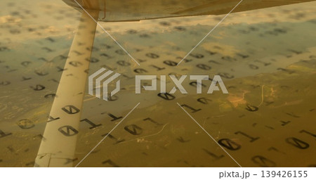 Metal wing support strut resting beside airplane window inside light aircraft, with binary overlay Metal wing support strut resting beside airplane window inside light aircraft, with binary overlay 139426155
