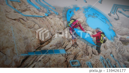 Assisting senior hikers scaling rock face, with red jackets, boots, packs and digital circuit globe Assisting senior hikers scaling rock face, with red jackets, boots, packs and digital circuit globe 139426177