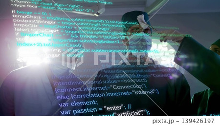 Demonstrating man wearing VR headset interacting with projected code in high-tech lab, with cables Demonstrating man wearing VR headset interacting with projected code in high-tech lab, with cables 139426197
