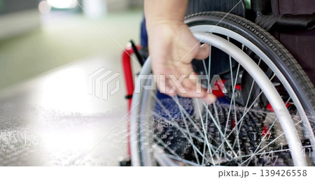 Guiding woman pushing wheelchair with right hand in hall, red frame denim pants overlay, copy space Guiding woman pushing wheelchair with right hand in hall, red frame denim pants overlay, copy space 139426558