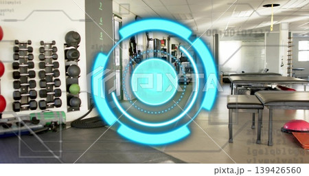 Displaying cyan AR circular HUD over rehab gym, revealing dumbbell rack, medicine balls, tire 139426560