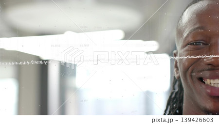 Smiling man with dreadlocks wearing dark top facing camera in office, waveform overlay, copy space Smiling man with dreadlocks wearing dark top facing camera in office, waveform overlay, copy space 139426603