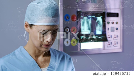 Operating technician in scrubs monitoring outlets and Xray monitors in diagnostic room, copy space Operating technician in scrubs monitoring outlets and Xray monitors in diagnostic room, copy space 139426733