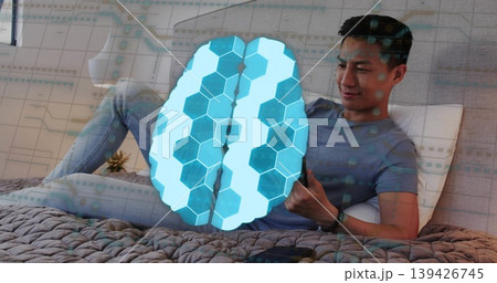 Man holding smartphone while reclining in bedroom, with knitted blanket, brain overlay, copy space Man holding smartphone while reclining in bedroom, with knitted blanket, brain overlay, copy space 139426745