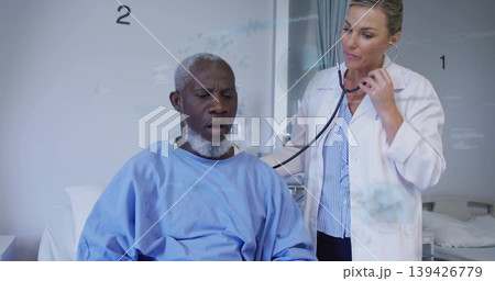 Examining doctor in white coat using stethoscope on patient back in hospital with privacy curtain 139426779