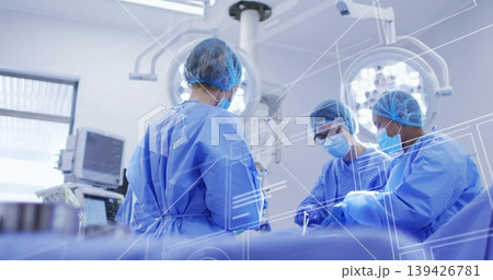 Operating surgical team performing operation in surgical suite, with lights and monitor overlays Operating surgical team performing operation in surgical suite, with lights and monitor overlays 139426781