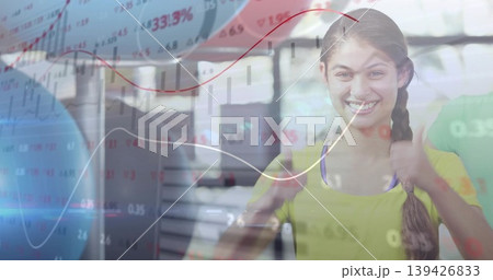 Smiling professional woman giving two thumbs up in modern office, with overlaid financial charts Smiling professional woman giving two thumbs up in modern office, with overlaid financial charts 139426833