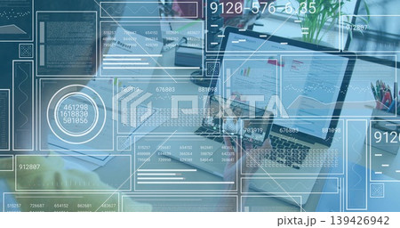 Displaying open laptop showing charts at desk with HUD and team wearing business-casual Displaying open laptop showing charts at desk with HUD and team wearing business-casual 139426942