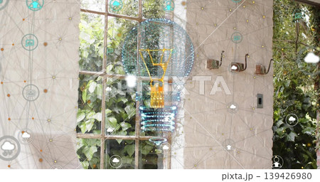 Projecting holographic lightbulb over wooden window and coat hooks in sunroom, with network icons 139426980