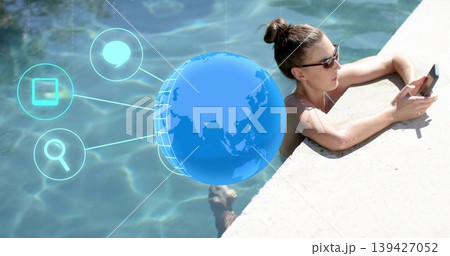 Leaning woman checking smartphone at pool, wearing swimsuit, sunglasses, digital icons, copy space Leaning woman checking smartphone at pool, wearing swimsuit, sunglasses, digital icons, copy space 139427052
