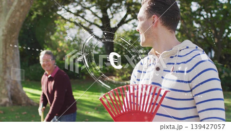 Raking man in white hoodie blue stripes in backyard, maroon sweater holding red rake, Euro HUD Raking man in white hoodie blue stripes in backyard, maroon sweater holding red rake, Euro HUD 139427057