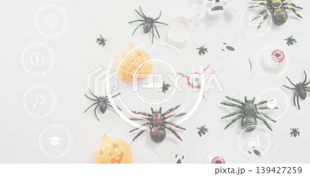 Showing red-accented black toy spider sitting centered on pale table, with Halloween props and HUD Showing red-accented black toy spider sitting centered on pale table, with Halloween props and HUD 139427259