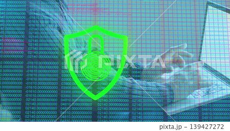 Reclining man wearing long-sleeve top and jacket using laptop on sofa, green shield padlock overlay Reclining man wearing long-sleeve top and jacket using laptop on sofa, green shield padlock overlay 139427272