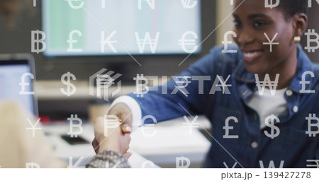 Shaking right woman in denim reaching across office with PC, docs and currency overlay, copy space Shaking right woman in denim reaching across office with PC, docs and currency overlay, copy space 139427278