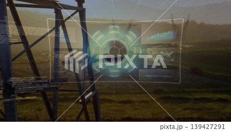 Floating clear hologram interface showing circular hub over fields at dusk, with tower and panels Floating clear hologram interface showing circular hub over fields at dusk, with tower and panels 139427291