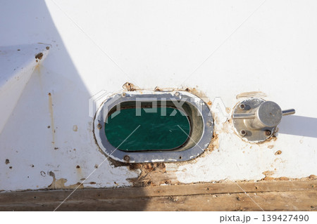 Nautical view through boat window with turquoise water 139427490