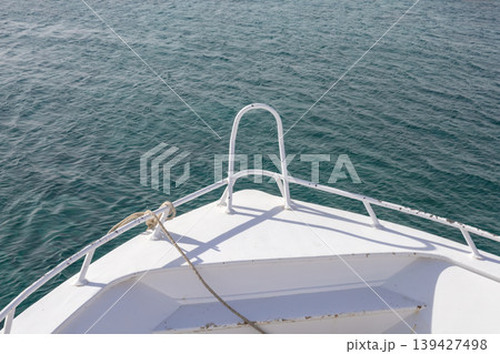 Serene ocean view from boat bow on a sunny day Serene ocean view from boat bow on a sunny day 139427498