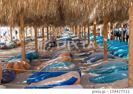 Beachside hammock retreat under straw canopies for tropical relaxation Beachside hammock retreat under straw canopies for tropical relaxation 139427531
