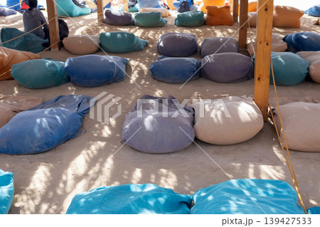 Relaxation zone with colorful bean bags in sunny outdoor setting Relaxation zone with colorful bean bags in sunny outdoor setting 139427533
