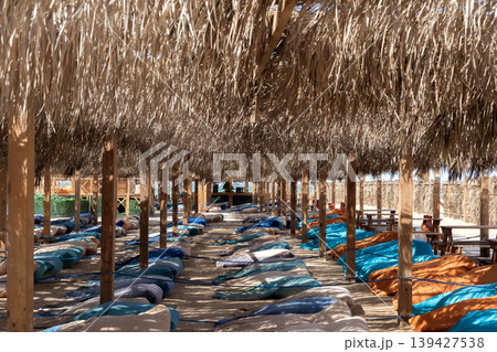 Serene outdoor beach hut retreat with lounge chairs in mediterranean sunlight 139427538