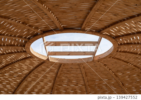 Intricate wooden dome ceiling with sky view - architectural art and design Intricate wooden dome ceiling with sky view - architectural art and design 139427552
