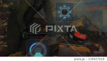 Crouching industrial worker wearing safety gear, using sledge in foundry with glowing metal and HUD Crouching industrial worker wearing safety gear, using sledge in foundry with glowing metal and HUD 139427819