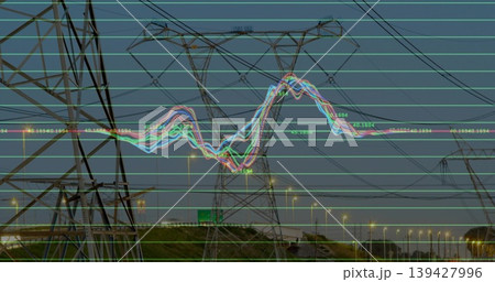 Dominating high-voltage lattice tower rising at dusk on highway, with waveform and streetlights Dominating high-voltage lattice tower rising at dusk on highway, with waveform and streetlights 139427996