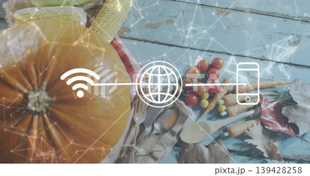 Showing large orange pumpkin on left, sitting on blue tabletop with corn, tomatoes, overlay icons Showing large orange pumpkin on left, sitting on blue tabletop with corn, tomatoes, overlay icons 139428258