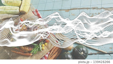 Displaying rustic spread with roasted bird, carrots, corn, tomatoes on blue planks, waveform 139428266