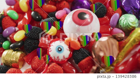 Featuring large white eyeball gumball on white table with wrapped eyeball candies rainbow overlays Featuring large white eyeball gumball on white table with wrapped eyeball candies rainbow overlays 139428386